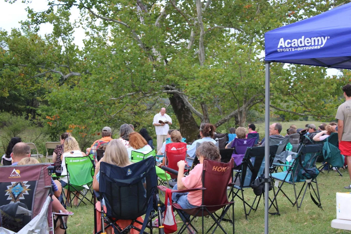 Open Door church families gathering outdoors for Bible teaching